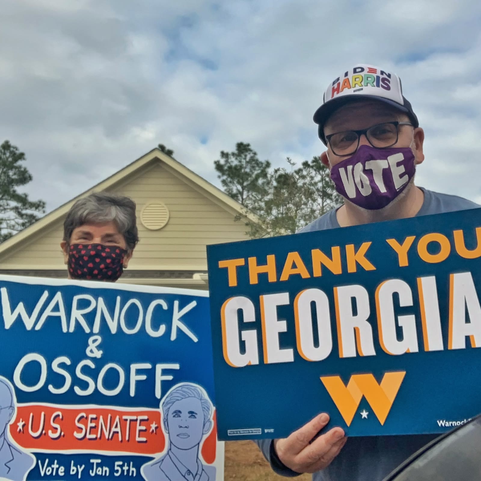 Blue Moreno and a volunteer holding Warnock and Ossoff campaign signs in Georgia