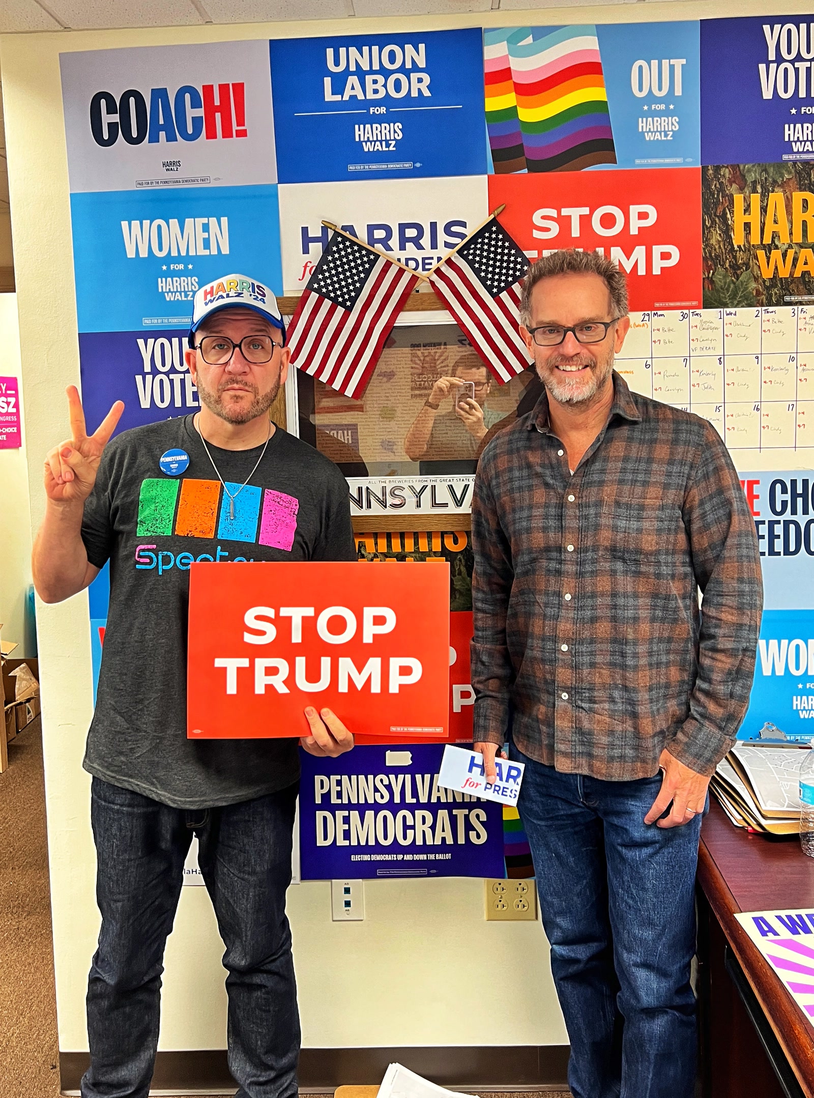 Blue Moreno holds a Stop Trump sign beside another volunteer in a Pennsylvania campaign office.