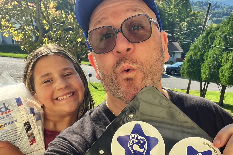 Blue Moreno and a young canvasser holding literature and a Deknockracy clipboard